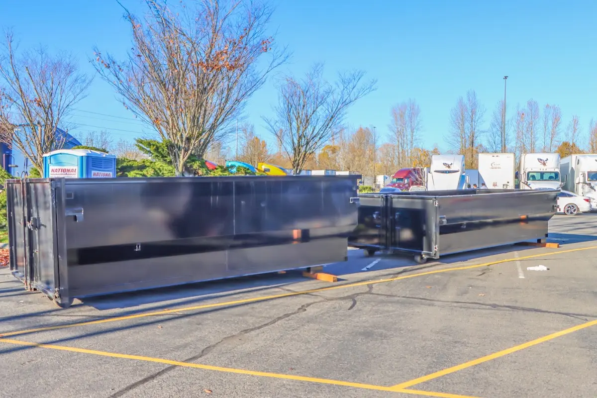 Professional dumpster rental service with roll-off container on residential driveway in Walden